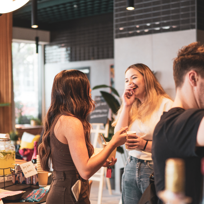 Image of people laughing at an UNCLE building